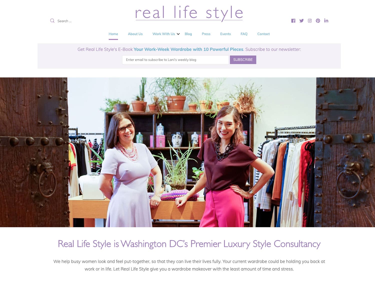 A screenshot of a website for women's style consultancy. The design is clean with a white background and bright, pastel-like lavender and blue for headings, the logo "Real Life Style" and some assorted navigation content and a "subscribe" bar. The main photo is of two women in in stylish, business-casual outfits seen standing in a chic, modern clothing boutique
